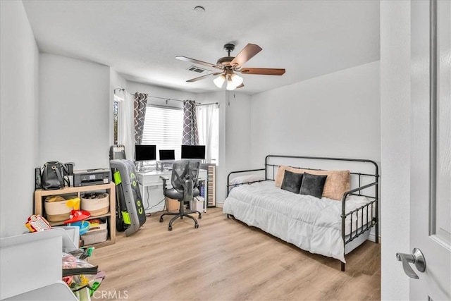 5947 Lupine Ave Unit 29, Palms, CA 92277 - bedroom featuring a desk, wood finished floors, and a ceiling fan