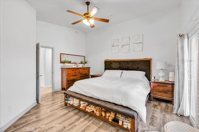 5947 Lupine Ave Unit 29, Palms, CA 92277 - bedroom with lofted ceiling, light wood finished floors, baseboards, and a ceiling fan
