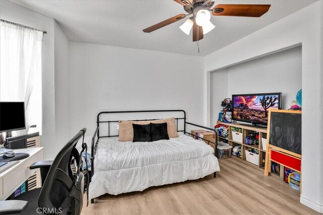 5947 Lupine Ave Unit 29, Palms, CA 92277 - bedroom with wood finished floors, a desk, and ceiling fan