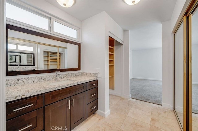 8072 Sundance Ln, La Palma, CA 90623 - full bath featuring vanity, a spacious closet, tile patterned floors, and baseboards