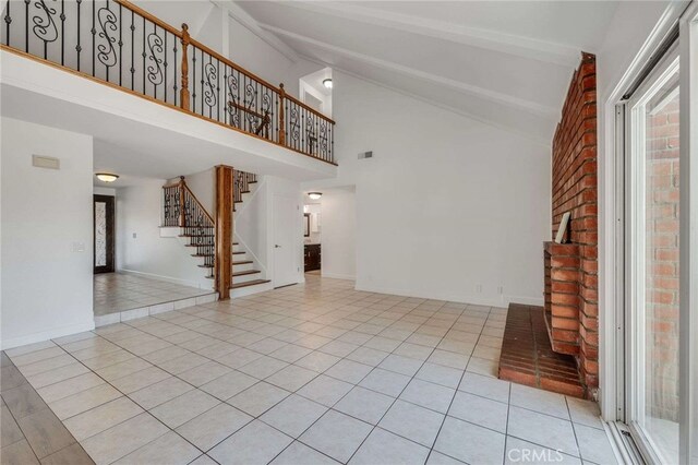 8072 Sundance Ln, La Palma, CA 90623 - unfurnished living room featuring healthy amount of natural light, stairs, high vaulted ceiling, tile patterned flooring, and beam ceiling