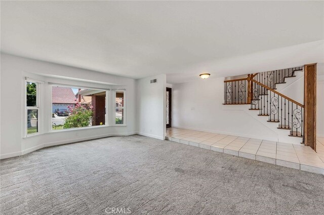 8072 Sundance Ln, La Palma, CA 90623 - unfurnished living room with plenty of natural light, carpet flooring, stairs, and baseboards