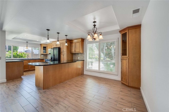 8072 Sundance Ln, La Palma, CA 90623 - kitchen with a raised ceiling, black fridge with ice dispenser, a peninsula, tasteful backsplash, and recessed lighting