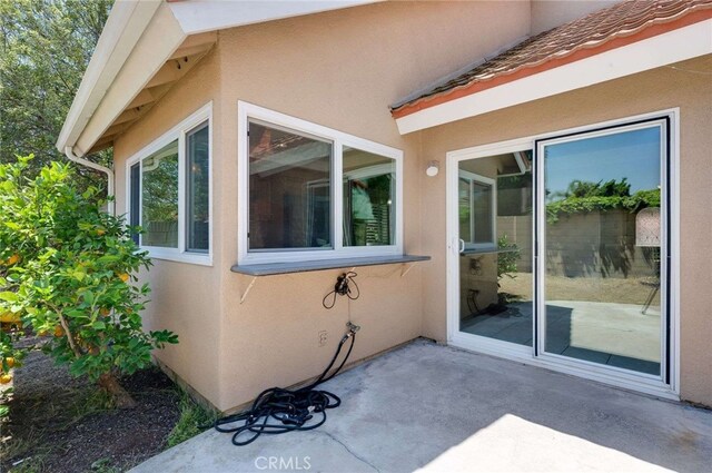 8072 Sundance Ln, La Palma, CA 90623 - view of home's exterior with stucco siding and a patio area