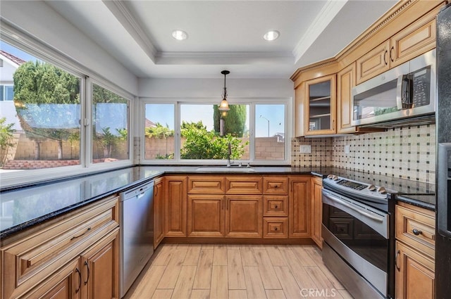 8072 Sundance Ln, La Palma, CA 90623 - kitchen with stainless steel appliances, a tray ceiling, tasteful backsplash, a sink, and glass insert cabinets