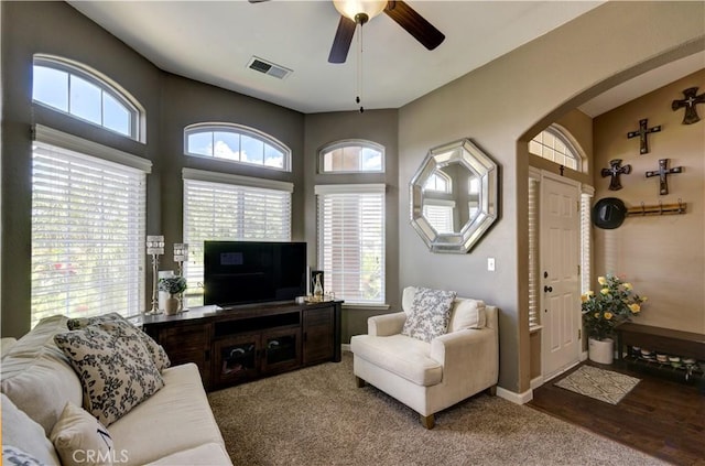 2267 Lorena Ave, Sanger, CA 93657 - living room with ceiling fan, arched walkways, baseboards, and carpet flooring