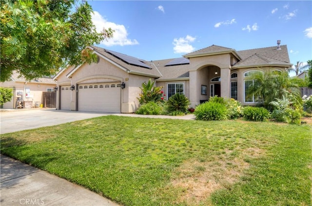 2267 Lorena Ave, Sanger, CA 93657 - view of front facade featuring a front lawn, concrete driveway, stucco siding, and roof mounted solar panels