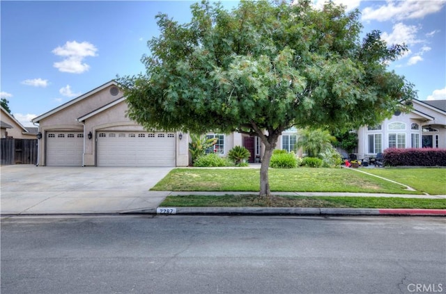 2267 Lorena Ave, Sanger, CA 93657 - obstructed view of property featuring a front lawn, driveway, a garage, and stucco siding