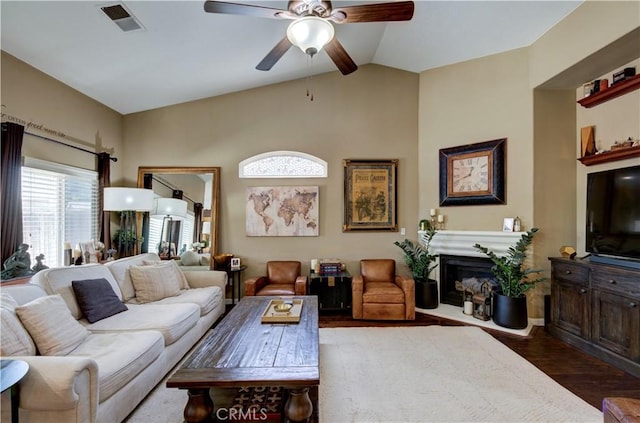 2267 Lorena Ave, Sanger, CA 93657 - living room featuring a ceiling fan, lofted ceiling, wood finished floors, and a glass covered fireplace