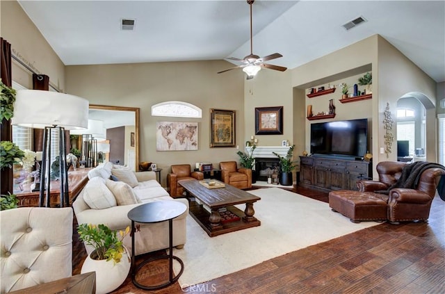 2267 Lorena Ave, Sanger, CA 93657 - living room with arched walkways, vaulted ceiling, a ceiling fan, wood finished floors, and a glass covered fireplace