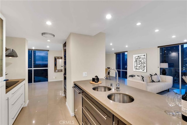 2160 Century Park E Unit 1512, Los Angeles, CA 90067 - kitchen featuring light tile patterned flooring, black appliances, recessed lighting, light countertops, and baseboards