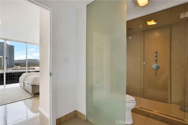 2160 Century Park E Unit 1512, Los Angeles, CA 90067 - full bath featuring tile patterned flooring, a stall shower, toilet, connected bathroom, and baseboards