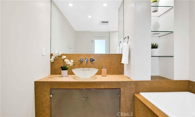 2160 Century Park E Unit 1512, Los Angeles, CA 90067 - full bath featuring tasteful backsplash, a tub, vanity, and recessed lighting