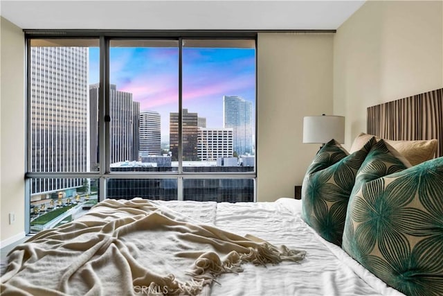 2160 Century Park E Unit 1512, Los Angeles, CA 90067 - bedroom with expansive windows, a skyline view, and baseboards