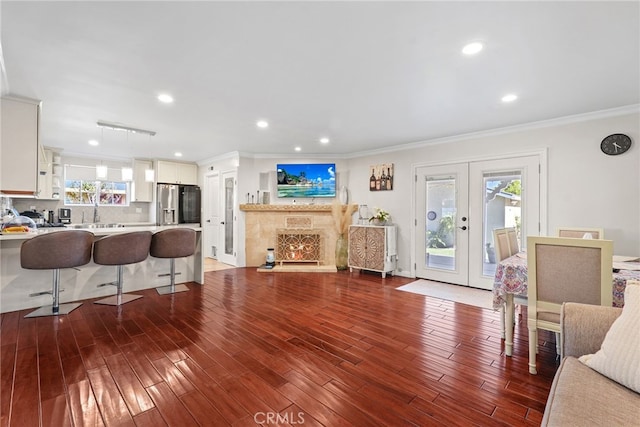 23920 Vanowen St, West Hills, CA 91307 - living area featuring ornamental molding, dark wood-style floors, french doors, and recessed lighting