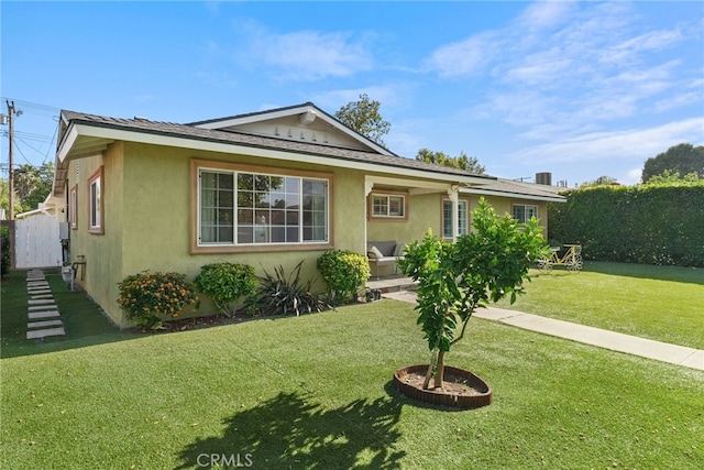 23920 Vanowen St, West Hills, CA 91307 - view of front of property with stucco siding and a front lawn