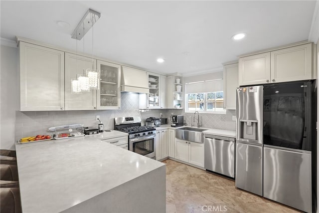 23920 Vanowen St, West Hills, CA 91307 - kitchen with stainless steel appliances, a sink, custom range hood, a peninsula, and light countertops
