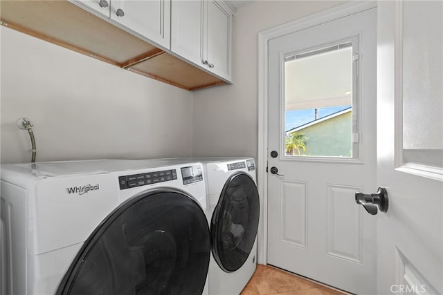 23920 Vanowen St, West Hills, CA 91307 - laundry room with cabinet space, washer and clothes dryer, and light tile patterned flooring