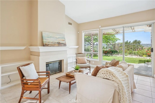 28291 La Plumosa, Laguna Niguel, CA 92667 - living room with light tile patterned floors, vaulted ceiling, and a glass covered fireplace