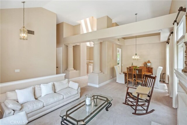 28291 La Plumosa, Laguna Niguel, CA 92667 - living area featuring light carpet, vaulted ceiling, and decorative columns