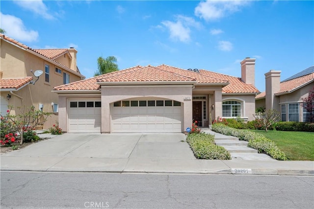 28291 La Plumosa, Laguna Niguel, CA 92667 - mediterranean / spanish-style house with a garage, concrete driveway, stucco siding, and a tiled roof