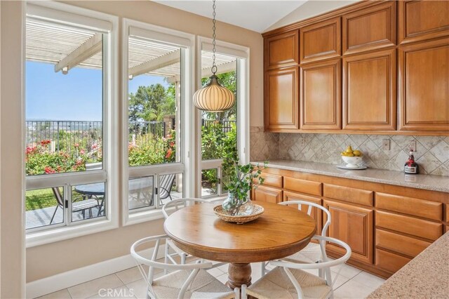 28291 La Plumosa, Laguna Niguel, CA 92667 - dining area featuring light tile patterned floors, lofted ceiling, and baseboards