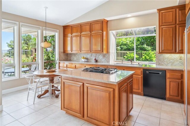 28291 La Plumosa, Laguna Niguel, CA 92667 - kitchen featuring dishwasher, vaulted ceiling, stovetop with downdraft, a sink, and brown cabinetry