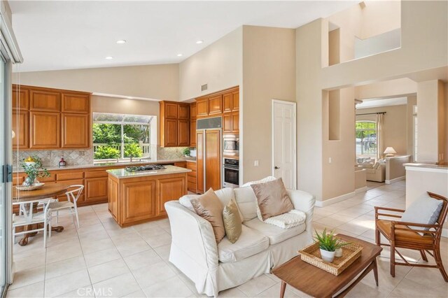 28291 La Plumosa, Laguna Niguel, CA 92667 - living area featuring light tile patterned floors, high vaulted ceiling, recessed lighting, and baseboards
