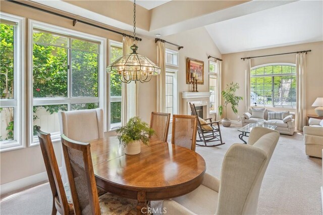 28291 La Plumosa, Laguna Niguel, CA 92667 - dining space featuring light colored carpet, vaulted ceiling, baseboards, and a chandelier