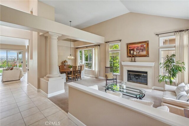 28291 La Plumosa, Laguna Niguel, CA 92667 - living area with light tile patterned floors, a premium fireplace, vaulted ceiling, light carpet, and healthy amount of natural light