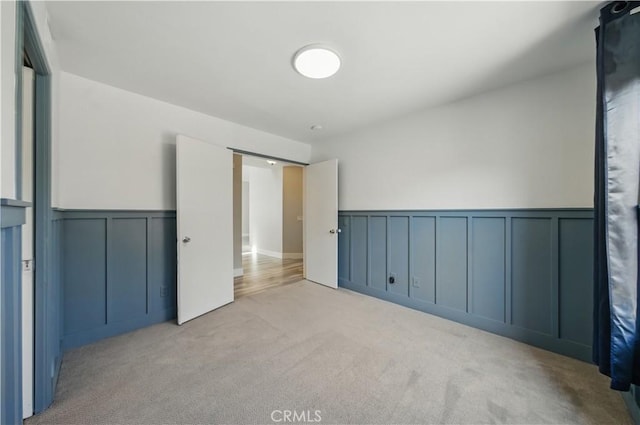 31070 Larchwood St, Menifee, CA 92584 - unfurnished bedroom with carpet flooring, a decorative wall, and wainscoting