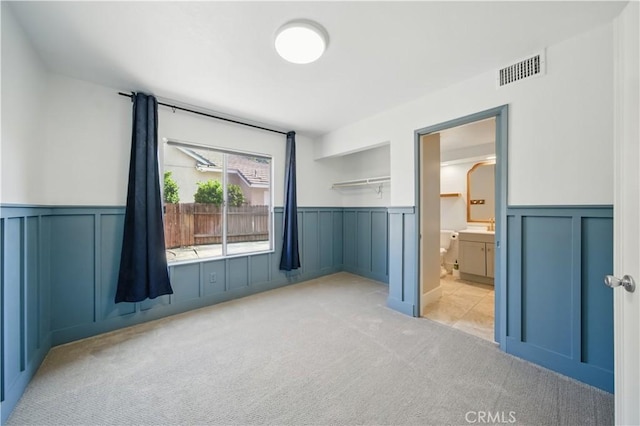 31070 Larchwood St, Menifee, CA 92584 - unfurnished bedroom with a wainscoted wall, carpet flooring, a decorative wall, and ensuite bathroom