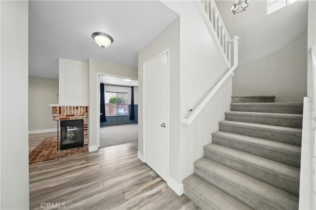 31070 Larchwood St, Menifee, CA 92584 - staircase featuring wood finished floors and a fireplace