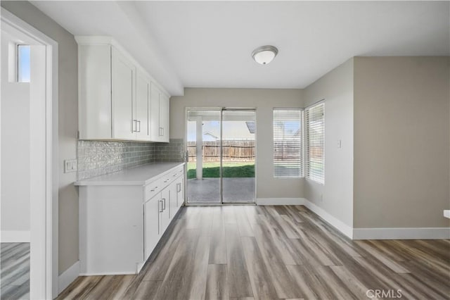 31070 Larchwood St, Menifee, CA 92584 - unfurnished dining area featuring light wood-type flooring and baseboards