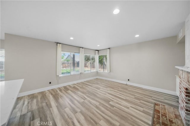 31070 Larchwood St, Menifee, CA 92584 - unfurnished living room featuring wood finished floors, recessed lighting, and a brick fireplace