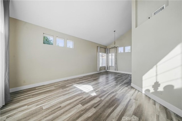 31070 Larchwood St, Menifee, CA 92584 - unfurnished living room with high vaulted ceiling, a chandelier, and wood finished floors