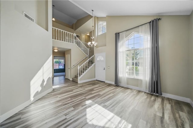 31070 Larchwood St, Menifee, CA 92584 - foyer entrance with stairway, wood finished floors, a chandelier, and high vaulted ceiling