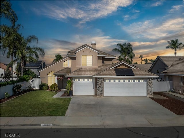 31070 Larchwood St, Menifee, CA 92584 - view of front of house with solar panels, stone siding, concrete driveway, an attached garage, and a chimney