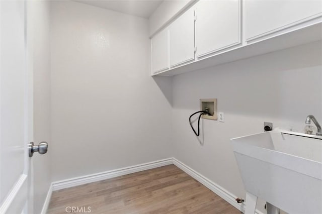 1272 Avenida Roundelay, San Jacinto, CA 92583 - laundry room featuring cabinet space, washer hookup, light wood-style floors, baseboards, and hookup for a gas dryer