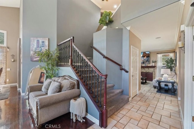 23328 Stone Rdg, Murrieta, CA 92562 - stairway featuring baseboards, ornamental molding, and a towering ceiling