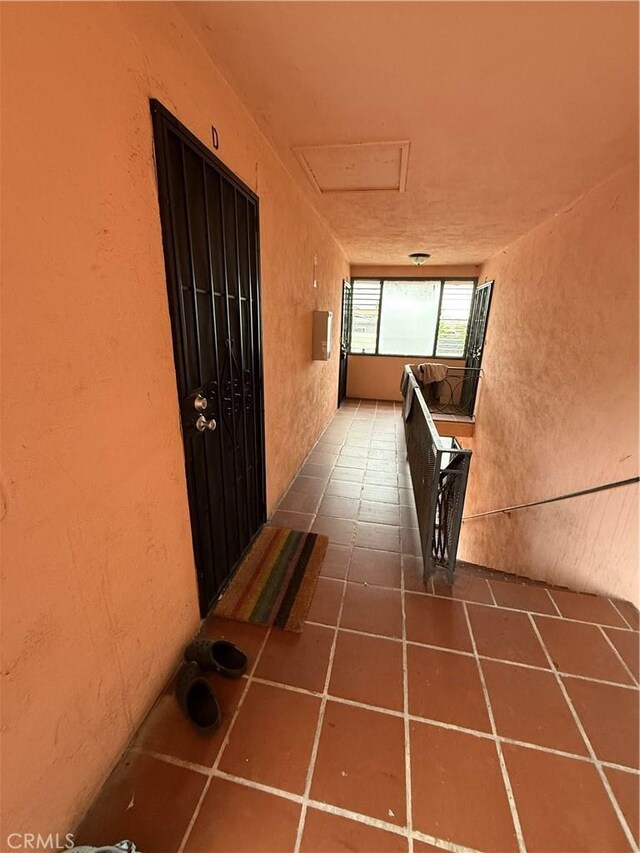 400401GRAND N Atlantic Blvd, Alhambra, CA 91801 - corridor with attic access, a textured wall, and tile patterned flooring