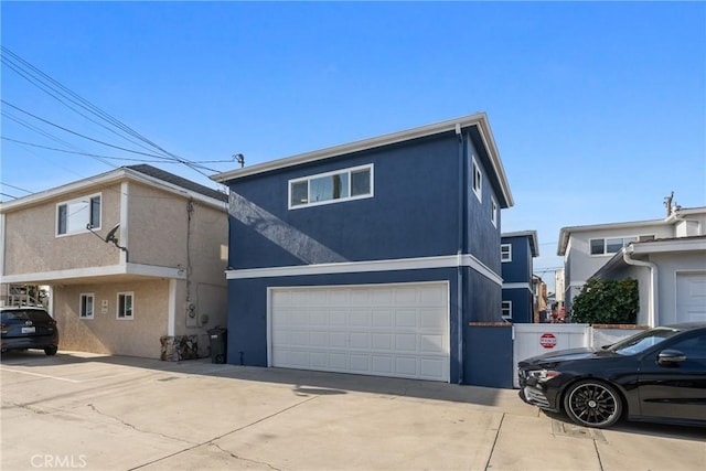 502 36th St, Newport Beach, CA 92663 - view of side of home with stucco siding, an attached garage, and concrete driveway
