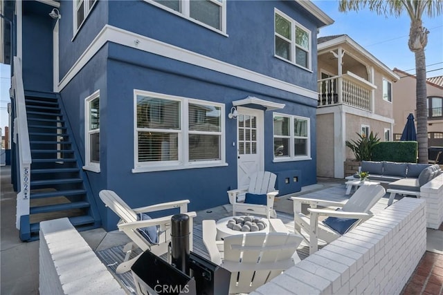 502 36th St, Newport Beach, CA 92663 - view of patio with stairway, a balcony, and an outdoor living space with a fire pit