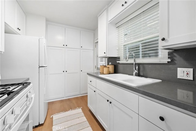 502 36th St, Newport Beach, CA 92663 - kitchen featuring a sink, light wood finished floors, white cabinets, and white gas range oven