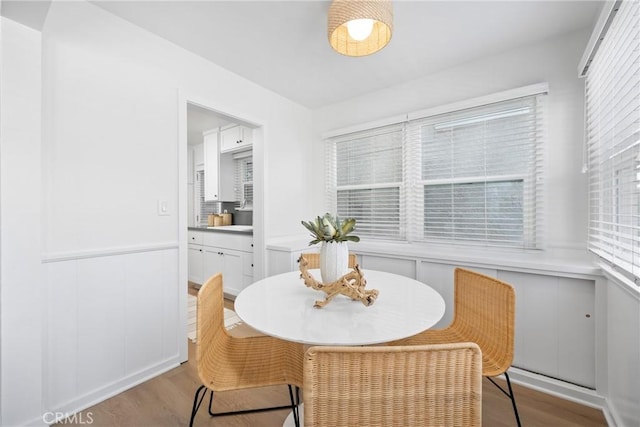 502 36th St, Newport Beach, CA 92663 - dining space with wood finished floors, healthy amount of natural light, wainscoting, and a decorative wall