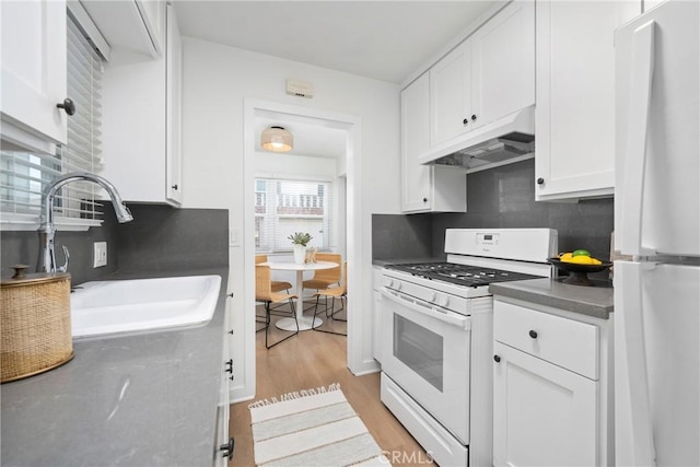 502 36th St, Newport Beach, CA 92663 - kitchen featuring white appliances, under cabinet range hood, a sink, white cabinetry, and light wood-style flooring