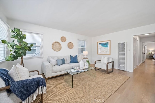 502 36th St, Newport Beach, CA 92663 - living area featuring a heating unit, plenty of natural light, wood finished floors, and baseboards