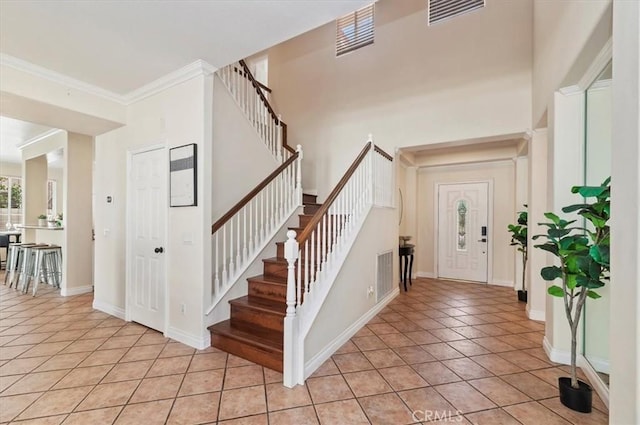 24320 Calle Estancia, Murrieta, CA 92562 - entryway with light tile patterned flooring, stairs, and ornamental molding