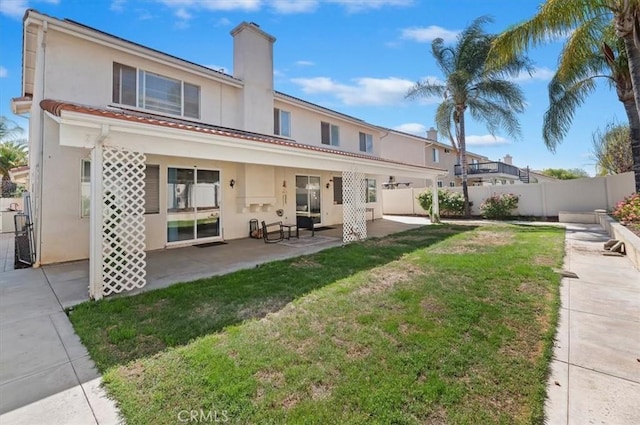 24320 Calle Estancia, Murrieta, CA 92562 - back of house with a patio area, stucco siding, a chimney, and a tile roof