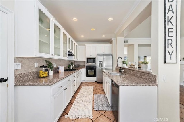 24320 Calle Estancia, Murrieta, CA 92562 - kitchen featuring black appliances, under cabinet range hood, crown molding, glass insert cabinets, and tasteful backsplash